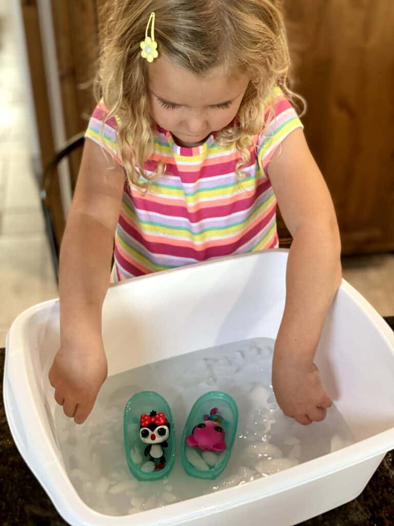 Imaginative play with Baby born Girl playing with two Baby born pet toys in an ice bath