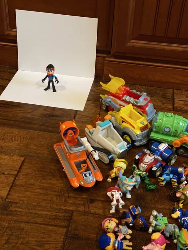 toy hunt for kids set up taking photos of Paw Patrol toys on a white backdrop