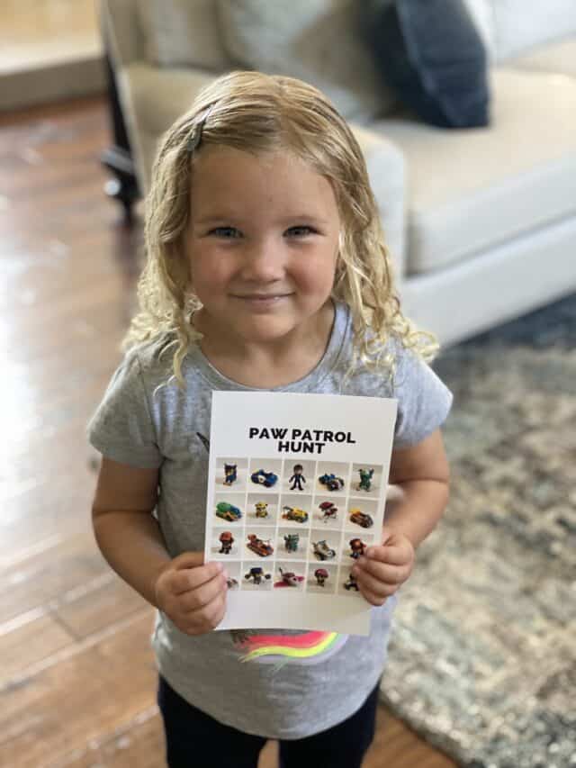 ready for a Paw Patrol Toy Hunt girl smiling holding a Paw Patrol scavenger hunt card